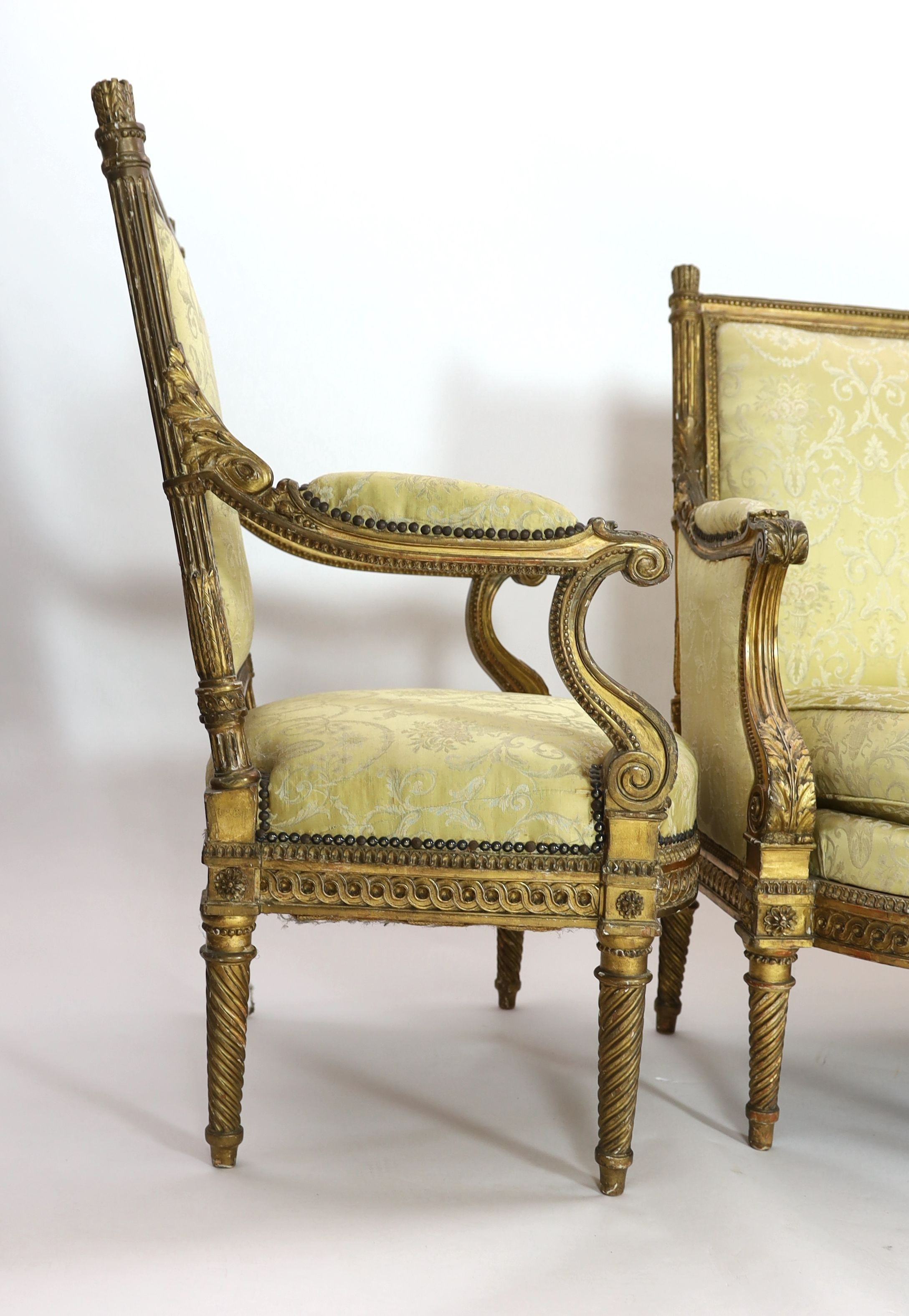 A Louis XVI carved giltwood five piece salon suite, settee W.148cm D.69cm H.100cm